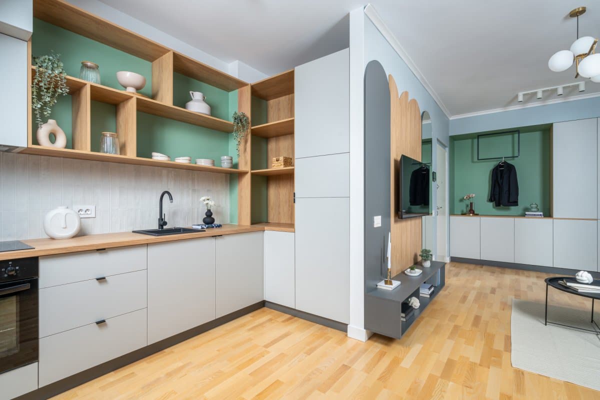 Bucătărie cu mobilier alb și rafturi verzi